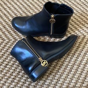 Michael Kors black leather ankle boots with gold zippers and MK charm size 6